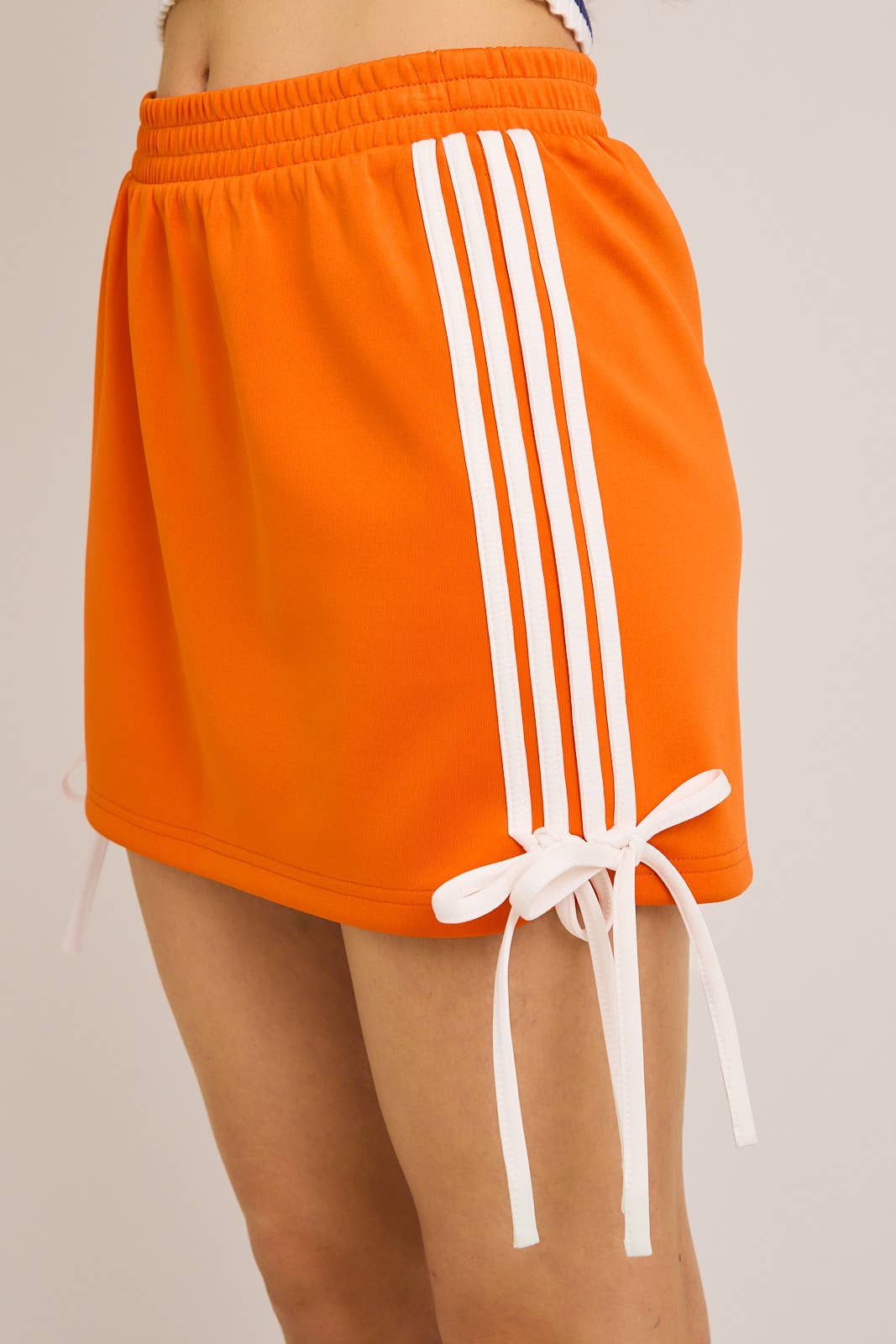 ORANGE BOW DETAIL TRACK MINI SKIRT