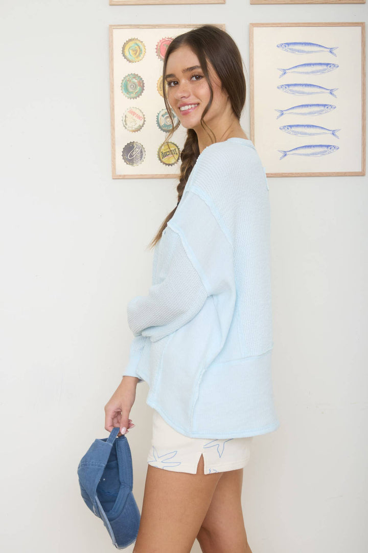 SPLIT NECK RAW EDGE LONG SLEEVE RIBBED KNIT TOP