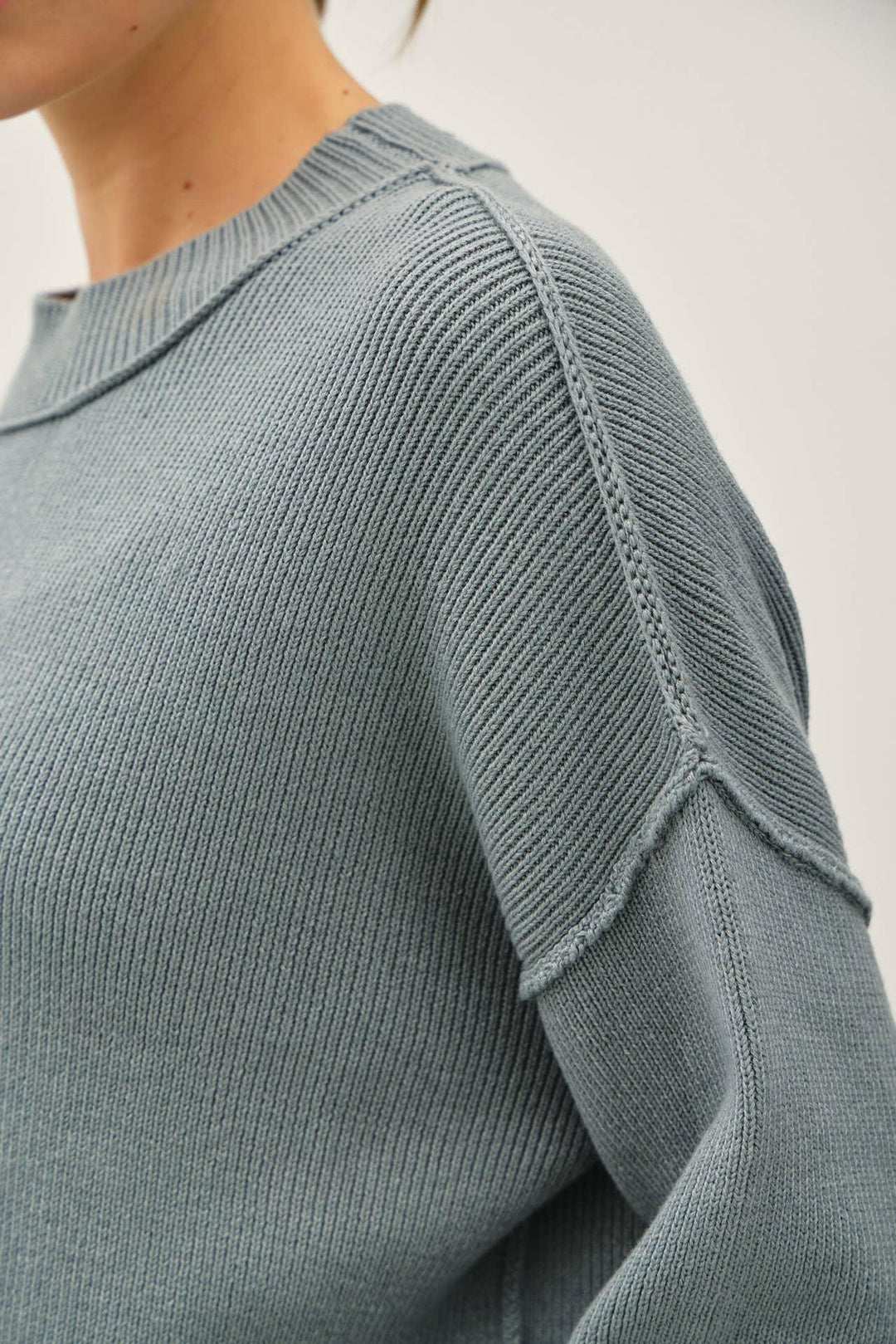RIBBED KNIT SWEATER WITH RAW SEAM DETAILS