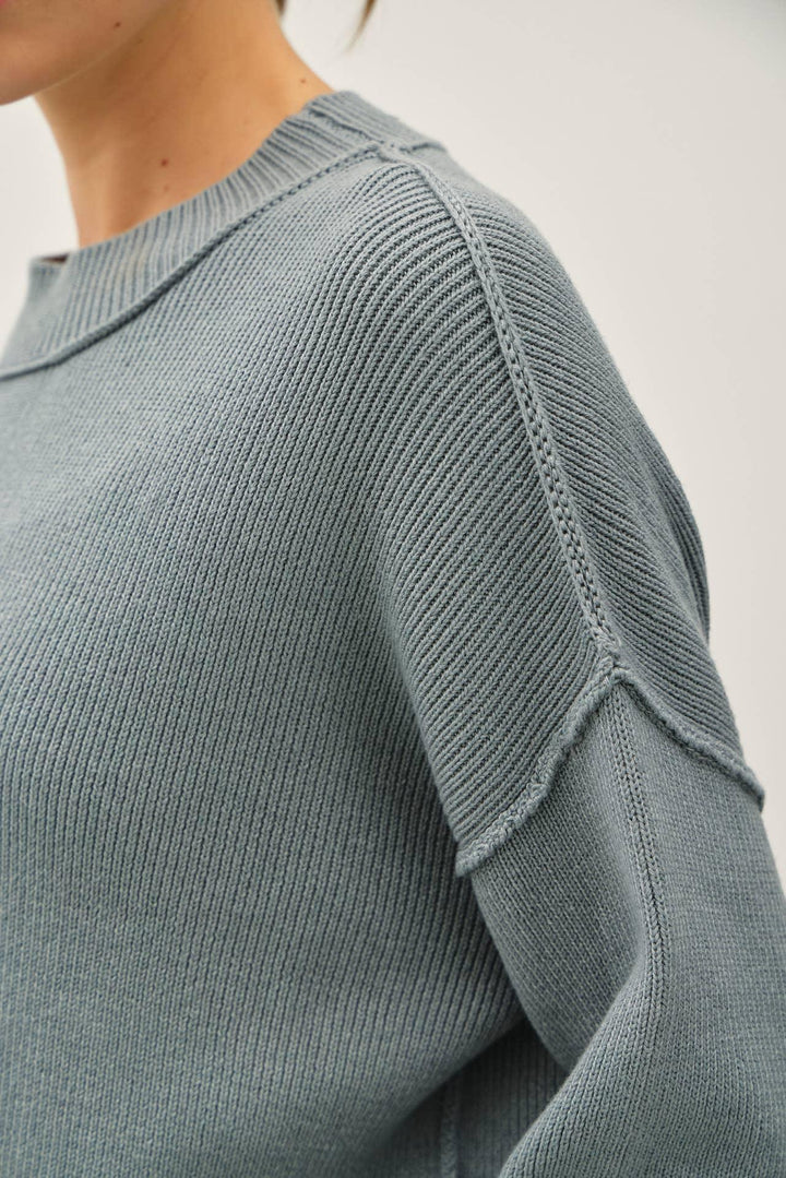 RIBBED KNIT SWEATER WITH RAW SEAM DETAILS
