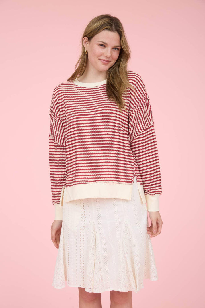 STRIPE EXPOSED SEAM SPLIT HEM LONG SLEEVE KNIT TOP
