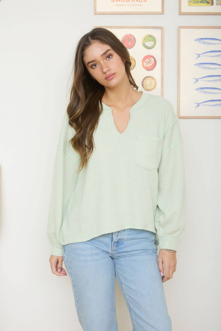 SPLIT NECK RAW EDGE LONG SLEEVE RIBBED KNIT TOP