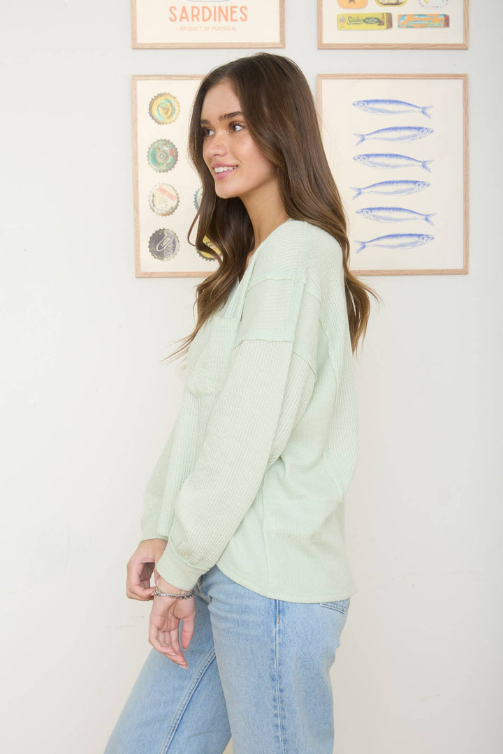 SPLIT NECK RAW EDGE LONG SLEEVE RIBBED KNIT TOP